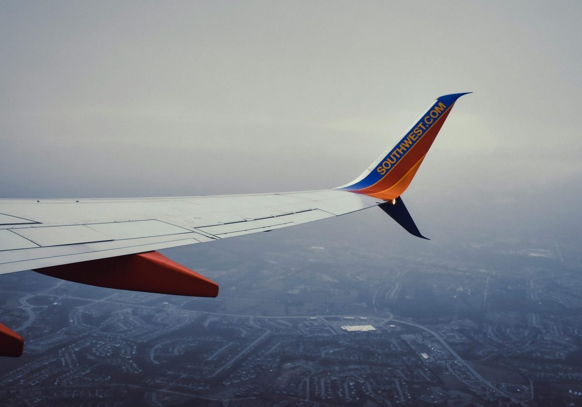 View from an airplane window over the wing at sunset