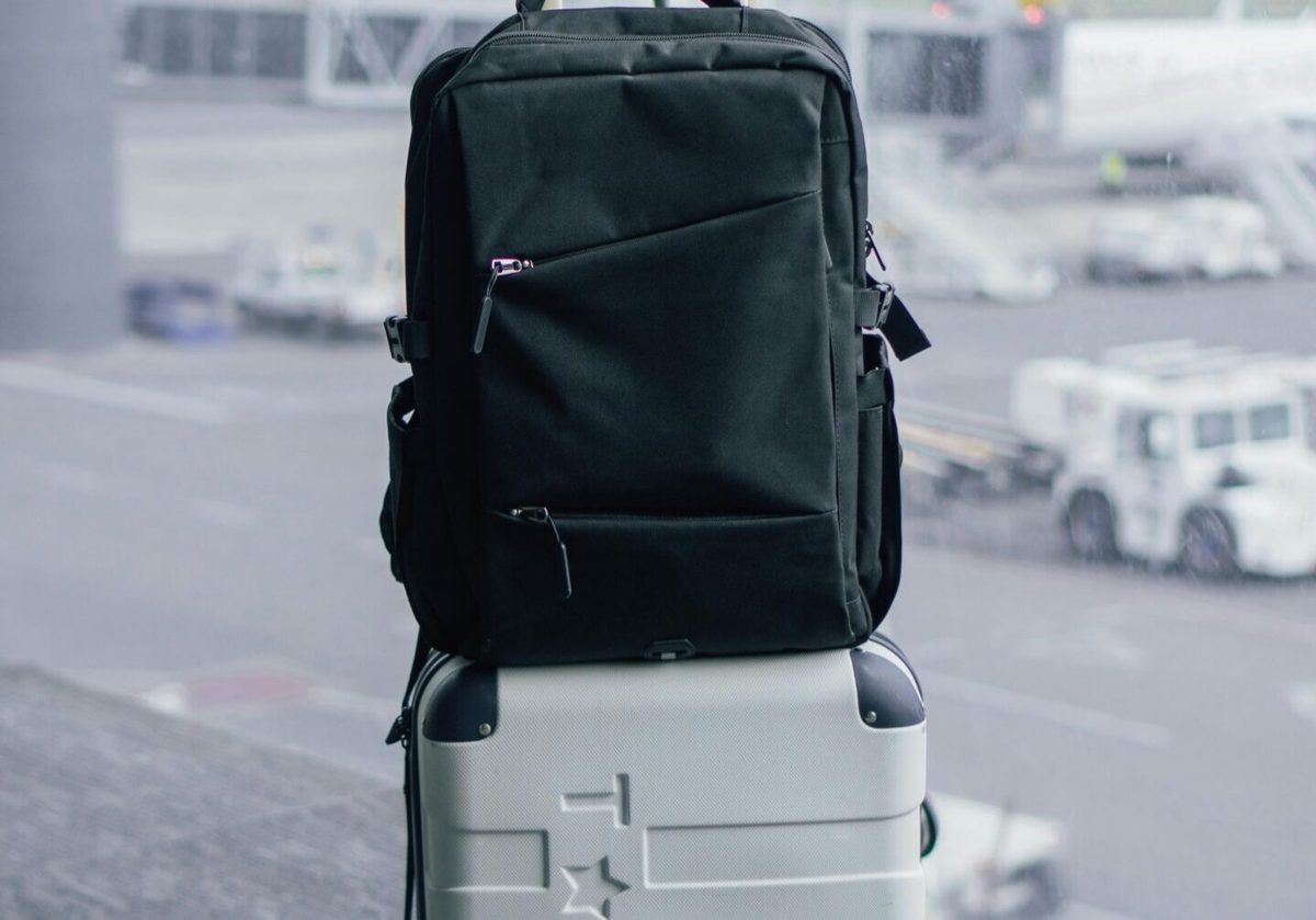 A backpack and suitcase packed and ready at the airport